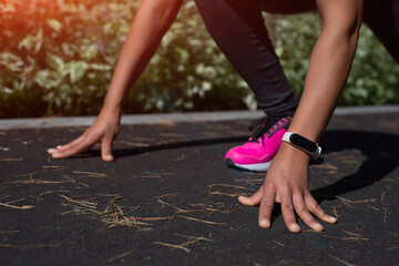 Runner start position. Closeup of female runner's hands on start position