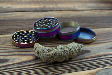 Medical Marijuana buds, weeds and grinder close up. Wooden backdround. Herbal medicine