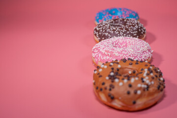 Sweet delicious donuts on a pink background
