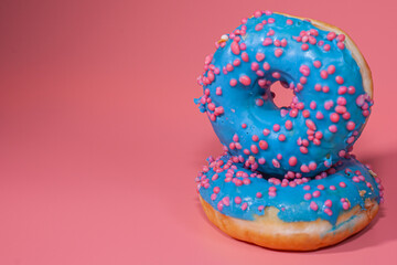 Sweet delicious donuts on a pink background