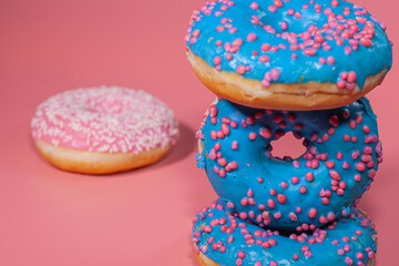 Sweet delicious donuts on a pink background