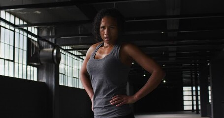 Portrait of african american woman taking a break breathing heavily and looking at the camera