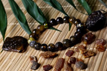 raw amber and amber in products on a natural background