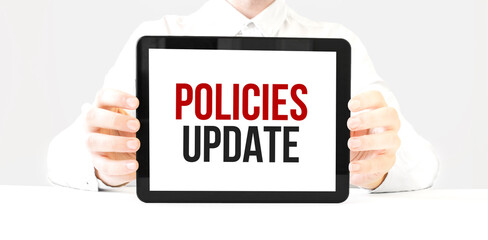 Text policies update on tablet display in businessman hands on the white bakcground. Business...