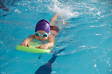 little girl swimming  in pool