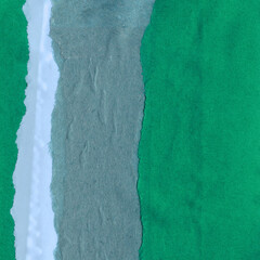 Colorful torn paper collage close-up. Texture made from various paper and cardboard parts. Damaged...