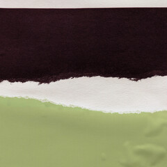 Colorful torn paper collage close-up. Texture made from various paper and cardboard parts. Damaged...