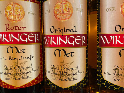 Viersen, Germany - January 9. 2020: Closeup of bottles with Wikinger honey wine met in shelf of german supermarket (focus on central bottle)