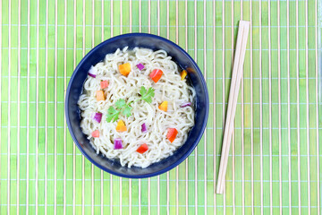 Pasta with vegetables in bowl, top view