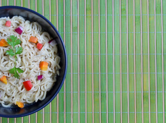 Pasta with vegetables in bowl, top view