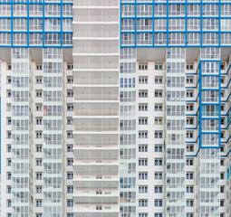 Fototapeta na wymiar Detail of facade a modern apartment building with repeating balconies and windows. Front view