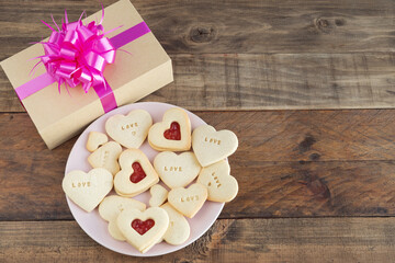 Dish with heart-shaped cookies on a wooden base. Concept Valentine's Day, Mother's Day, anniversary.