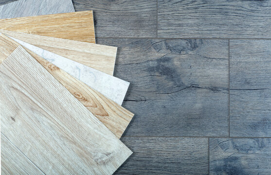 Vinyl and linoleum samples on a wooden background. Vinyl for flooring with  wood grain texture and pattern. Stock Photo | Adobe Stock
