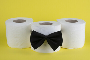 Three rolls of toilet paper on a yellow background. Creative composition.