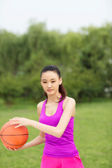 Young woman holding a basketball