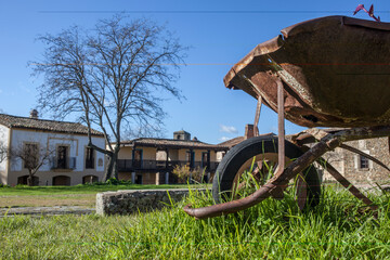 Old rusty handbarrow reused as a planter, Granadilla, Extremadura