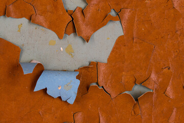 Peeling paint on the wall. Old concrete wall with cracked flaking paint. Weathered rough painted...
