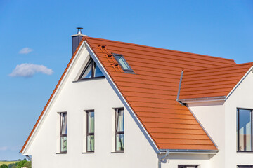 house with new red tiled roof, blue sky