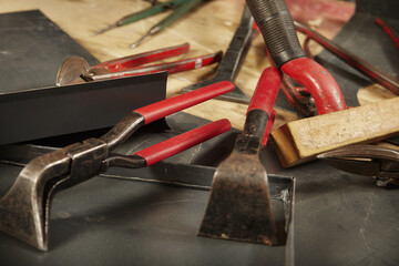 Detail of pliers and trimming tools of roof plumbers on table