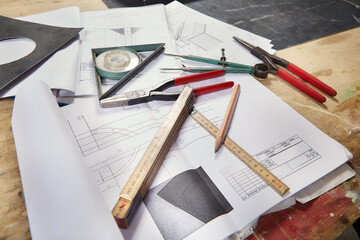 Detail of tools, folding meter, inclinometer and drawing on table