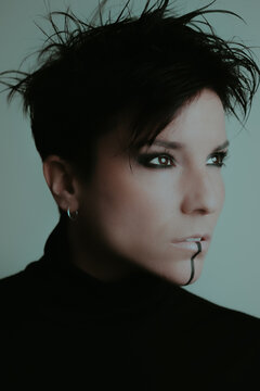 Portrait of an attractive woman with dark makeup in studio