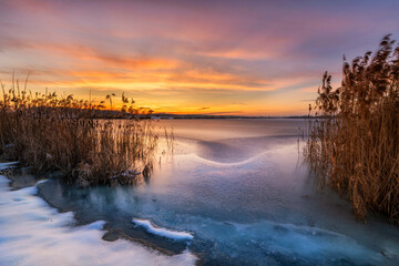 Beautiful winter sunset over the frozen lake