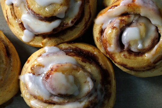 Close Up View Of Fresh Cinnamon Rolls With Icing Drizzle From Top View For Breakfast Food.