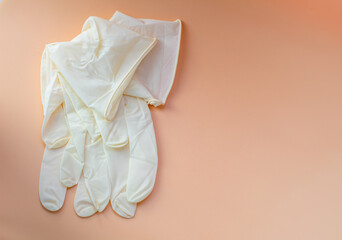 Obraz premium light, rubber, disposable gloves on a yellow background, close-up