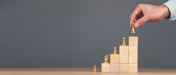 Chess standing on a pyramid of wooden building block