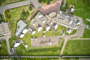 Aerial of buildings with satellite radar dishes top down view