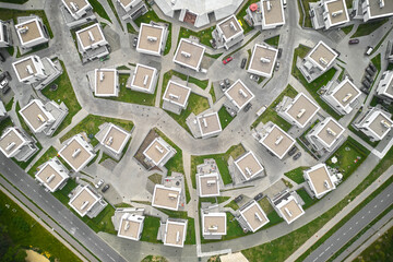 Top down aerial view of small houses in private residential area