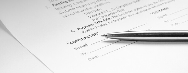 Obraz premium Close-up of a silver pen on docunent contract. Legal contract signing. Buy sell real estate contract agreement. Customer sign on document paper with silver pen