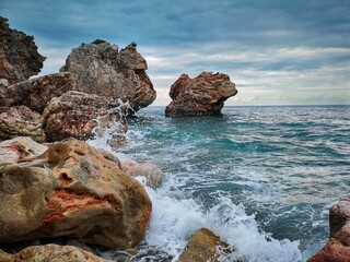 close-up sea waves hitting stones