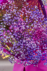 Big pink and purple bouquet of gypsophila, florist shop photo, flower lay out, violet background