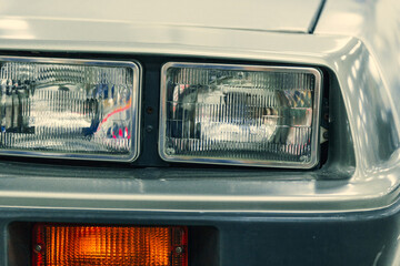 Obraz premium close-up halogen headlight of white retro car.