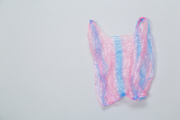 used purple plastic disposable bag on gray background