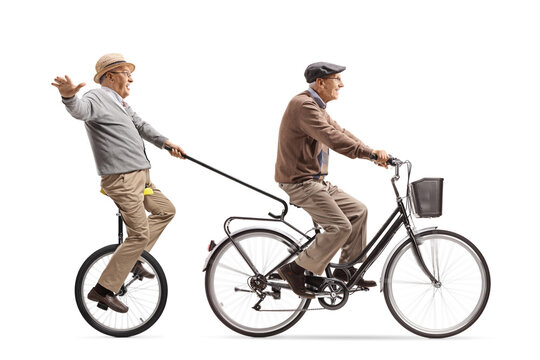 Elderly man riding a bicycle and pulling another man with a tricycle