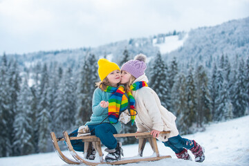 Happy winter children. Happiness and kids love. Little couple kiss. Child friends kissed.