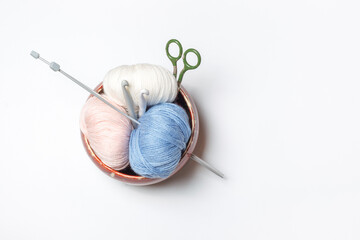 box for needlework with yarn ball in pastel colors, a knitted product and a vintage product on a...