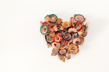 Colored graphite wooden pencil sharpener on white background. Heart shape.