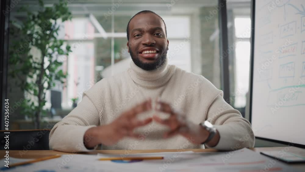 Poster Point of View from Camera with Handsome Young Black Project Manager Making a Video Call in Creative Office Environment. Happy African American Male Specialist Talking to Colleague Over a Live Camera.