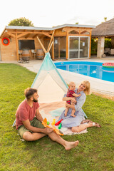 Parents playing with their baby boy in the backyard