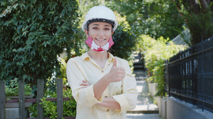 Virus and disease prevention concept. Portrait of an engineer woman wearing a protective medical...