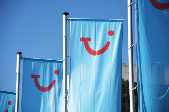 Hannover, Lower Saxony, Germany - April 5, 2020: Flags of TUI Group in front of headquarters in Hannover, Germany - TUI is the lagest leisure, travel an tourism company in the world