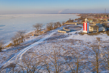 aerial view to lighthouse in sun lights behind trees