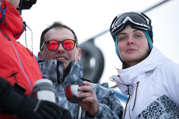 Group Of Friends Enjoying Hot Mulled Wine In Cafe At Ski Resort