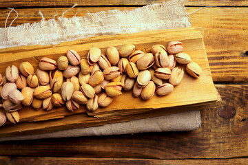 pistachio nuts close-up on a wooden surface selective focus.