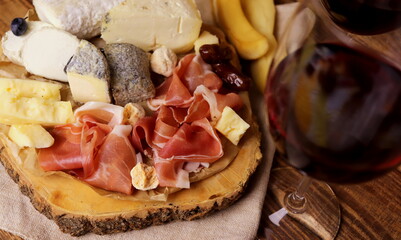 different types of cheeses with delicacy meat wooden surface selective focus. cheese platter.