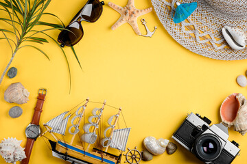 Seashells, souvenirs and camera. Watch, sunglasses and hat