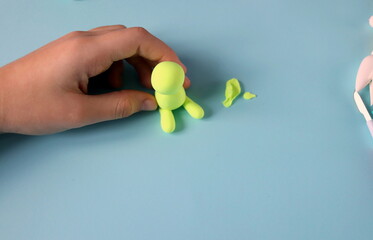 how to make a figurine from plasticine bunny step by step step 3 selective focus. children's crafts. handwork.